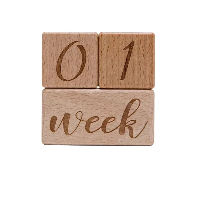 Three wooden blocks with engraved numbers and the word 'week', showing measurements and weight.