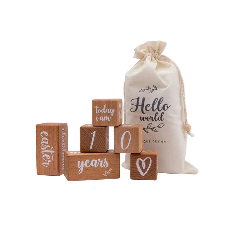 Wooden blocks with text and measurements, accompanied by a 'Hello world' drawstring bag.