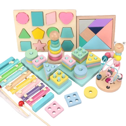 Assorted wooden toys including shape sorting and stacking toys on a wooden surface.
