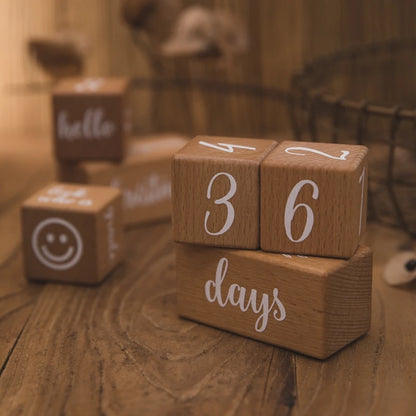 Wooden blocks with numbers and letters on a wooden surface