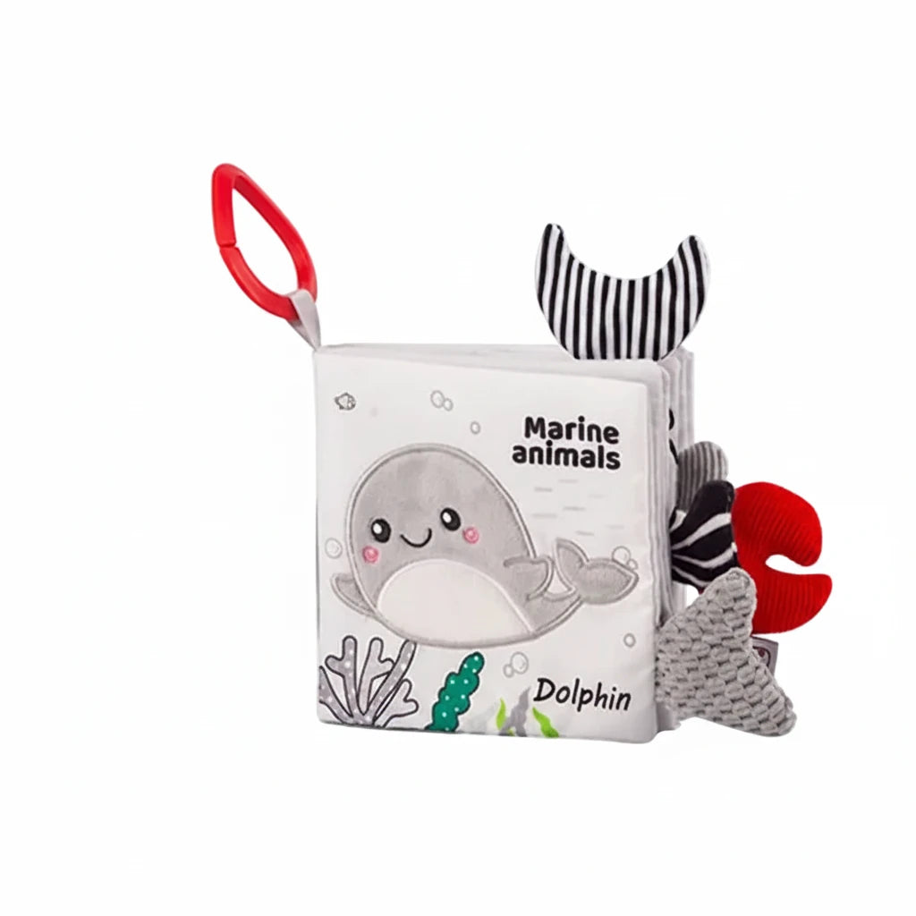 Children's soft book with marine animal illustrations and a dolphin on a white background