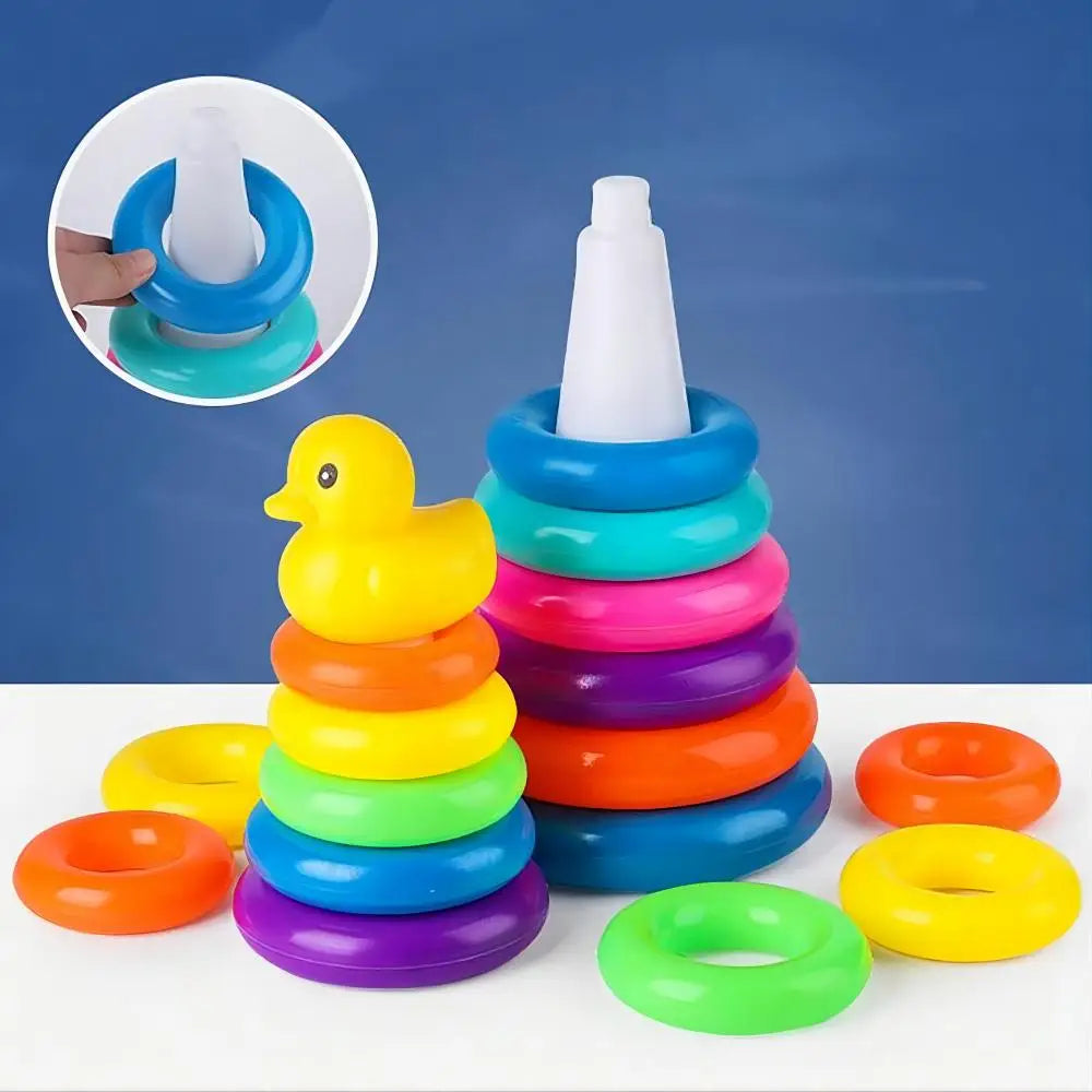 Colorful stacking rings toy with a yellow duck on a white surface against a blue background