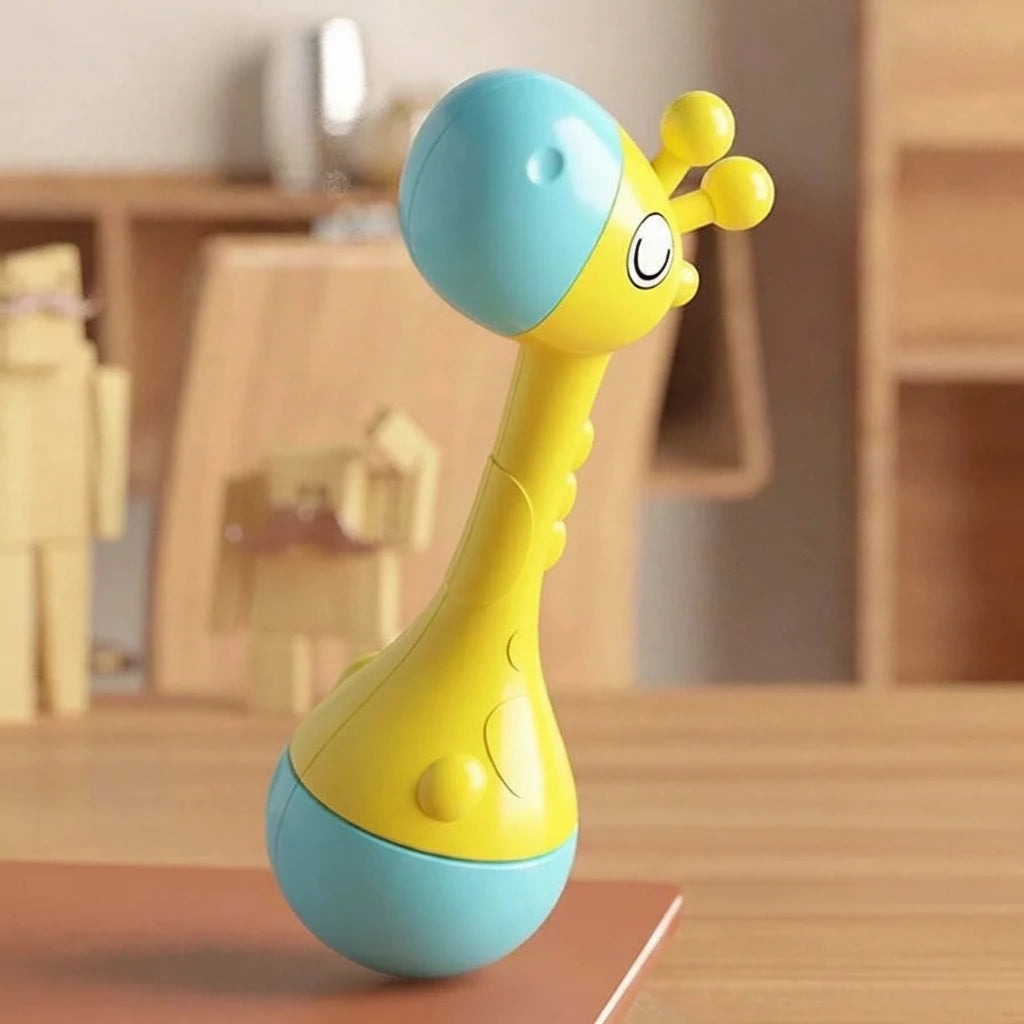 Yellow and blue toy with a face on a wooden surface
