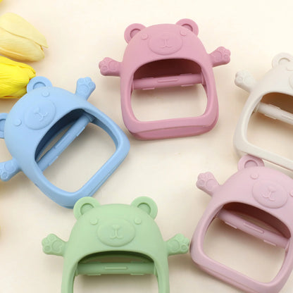 Colorful bear-shaped clips on a light pink background