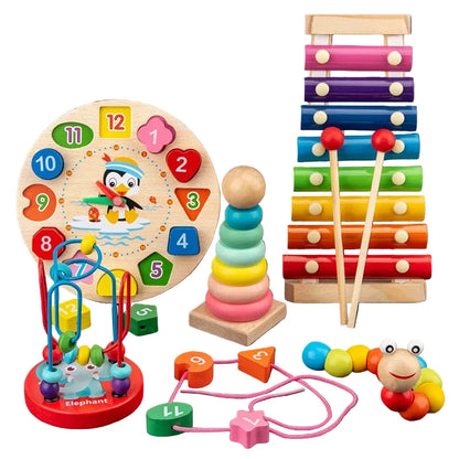 Assorted wooden toys including a clock, xylophone, and other educational items on a dark surface with books in the background.