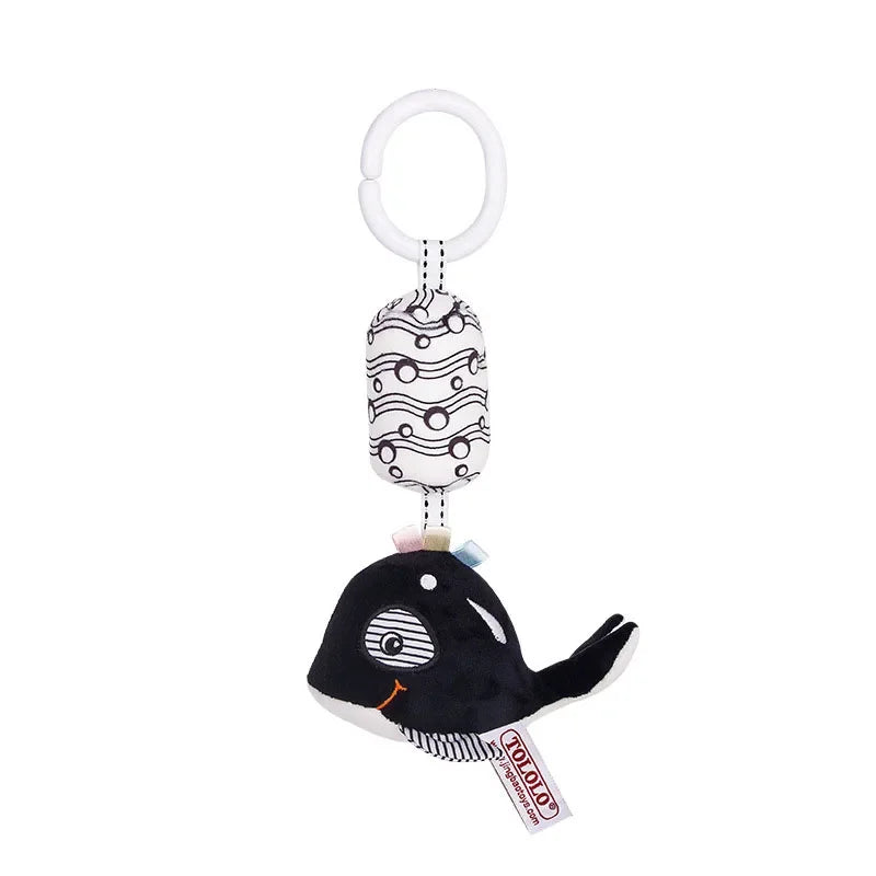 Black and white whale-shaped keychain with a patterned tag on a white background