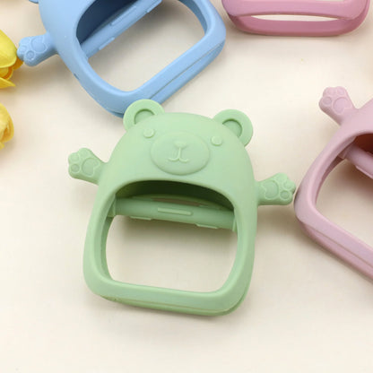 Colorful silicone bear-shaped bottle openers on a light background