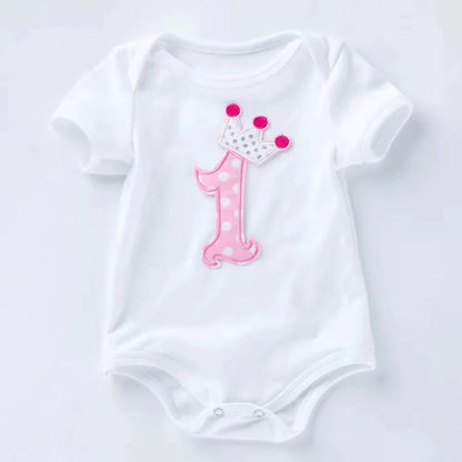 White baby onesie with pink number one and crown on a white background