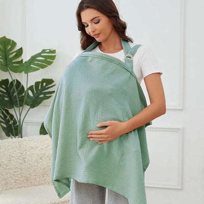 Woman wearing a green baby carrier with a white background
