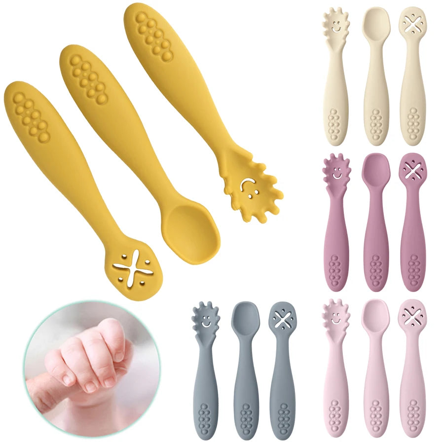 Set of baby utensils including spoons and a fork with different designs on a white background.