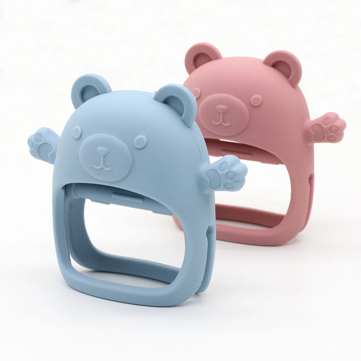 Two bear-shaped silicone phone holders, one blue and one pink, on a white background.