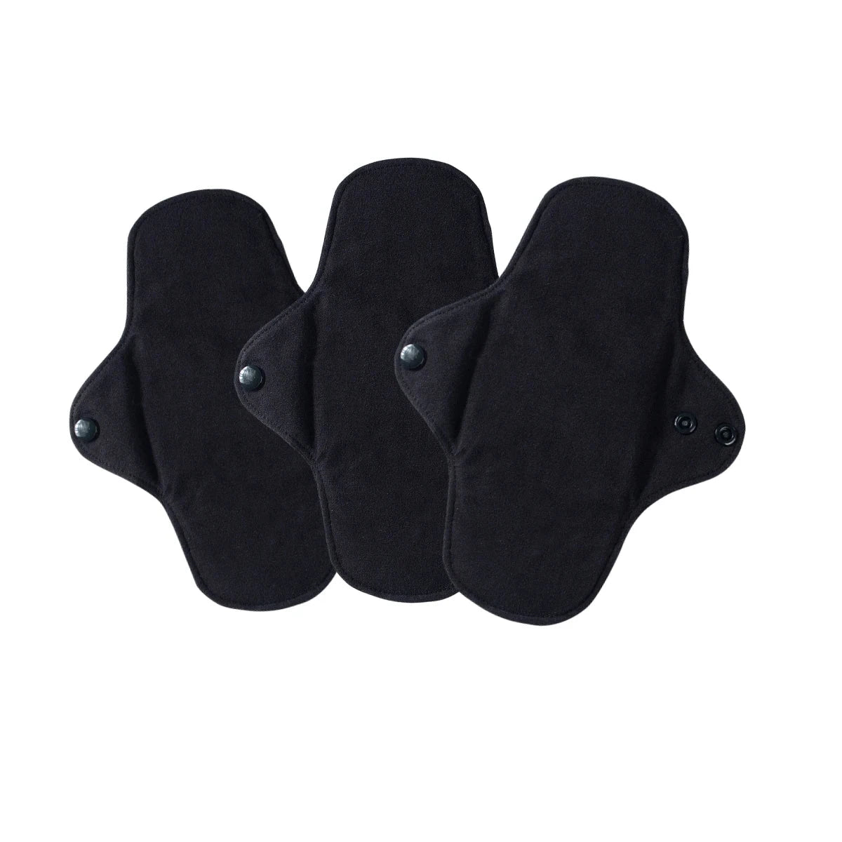 Three black cloth pads with adhesive patches on a white background