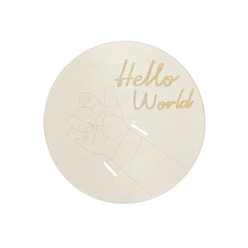 Round white object with 'Hello World' text and a baby illustration on a white background