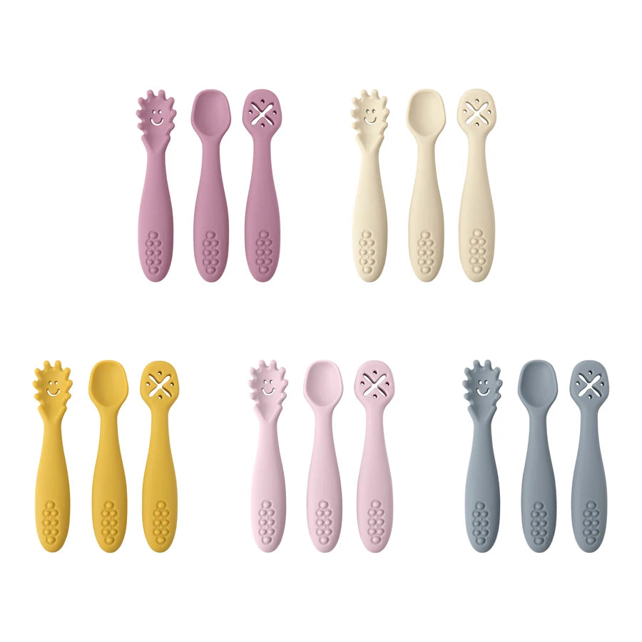 Set of colorful baby utensils including spoons and forks on a white background