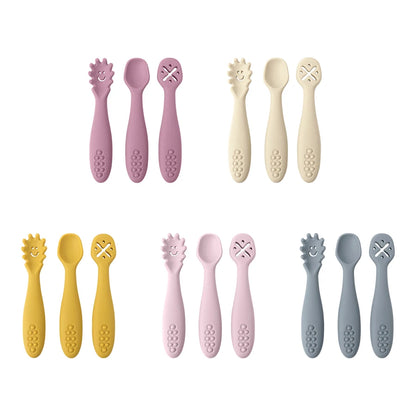 Set of colorful baby utensils including spoons and forks on a white background