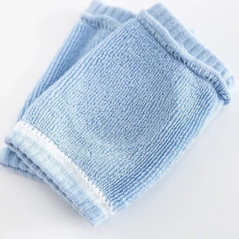 Stack of light blue washcloths on a white background