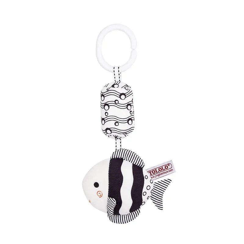 Black and white striped fish-shaped keychain with a visible brand logo on a white background