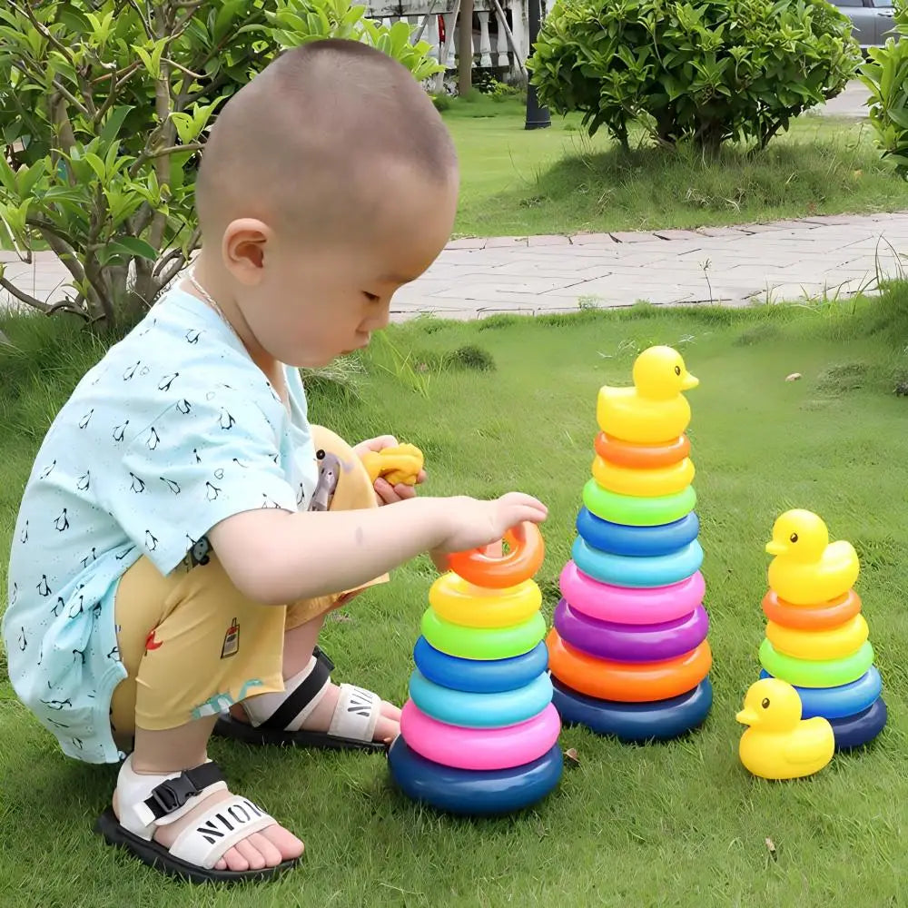 Child playing with colorful ring and duck toy set outdoors