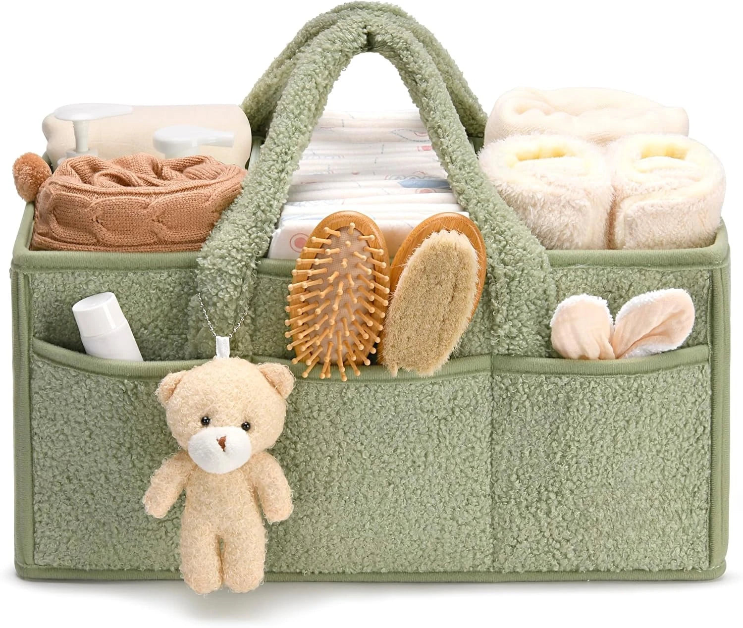 Green baby caddy with baby items including a teddy bear, blanket, and bottles on a white background