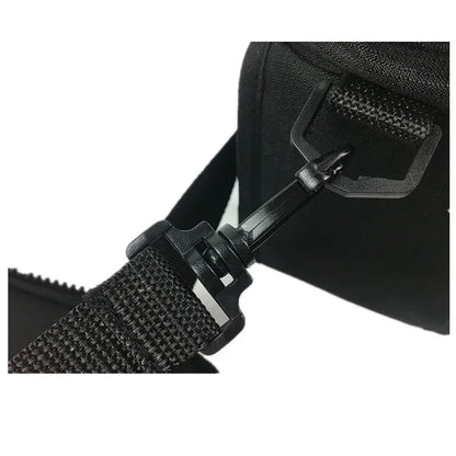 Close-up of a black bag with a strap and buckle on a white background