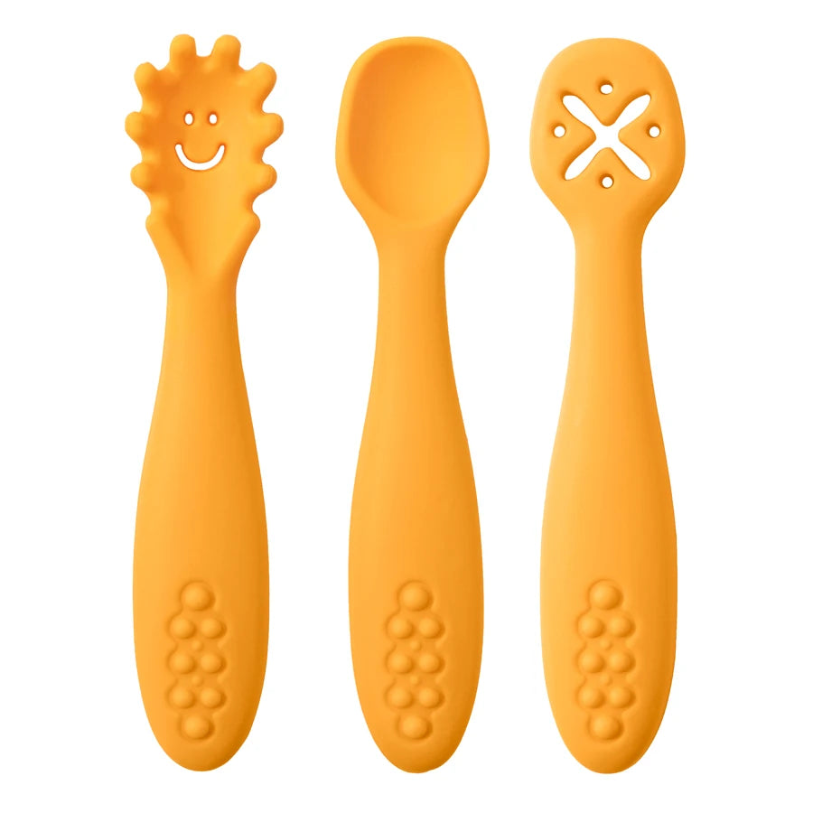Three orange baby utensils with different textures on a white background