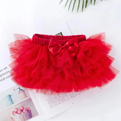 Red tutu skirt with a bow on a white surface