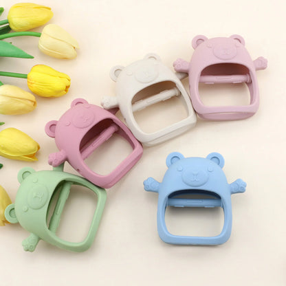 Colorful bear-shaped plastic buckles on a light background with yellow tulips.