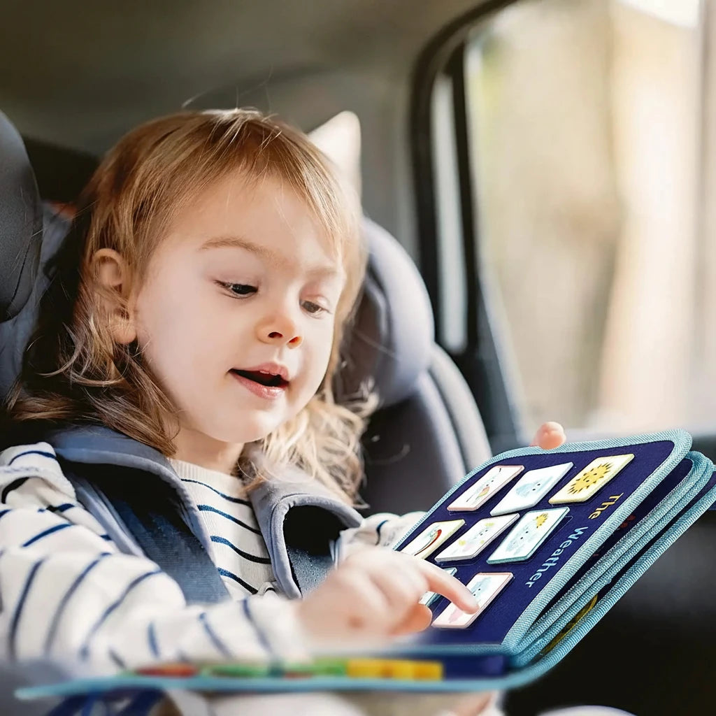 Child in a car seat using a portable educational book with text 'Portable for Travelling Keep Toddler Busy & Entertained'.