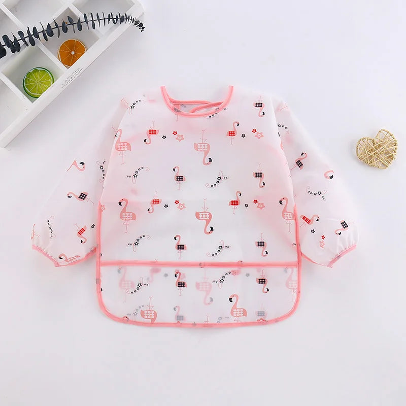 Baby bib with flamingo pattern on a white surface