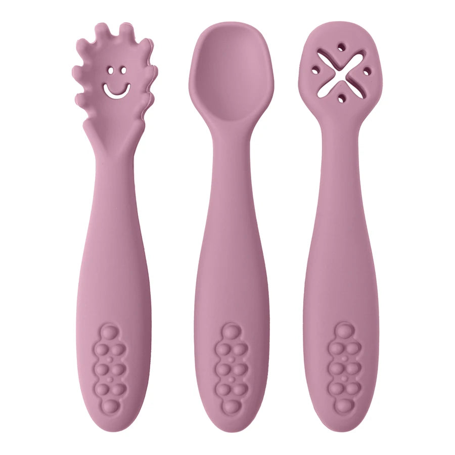 Three pink baby utensils with different designs on a white background