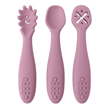 Three pink baby utensils with different designs on a white background