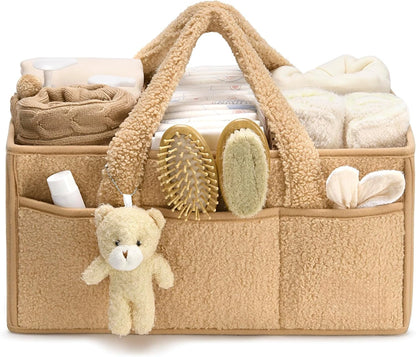 Beige baby organizer with baby items including a teddy bear, on a white background