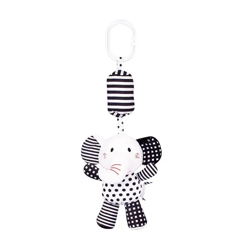 Black and white striped elephant toy with a polka dot pattern on a white background