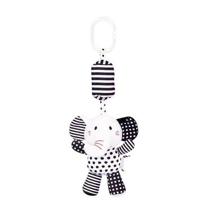 Black and white striped elephant toy with a polka dot pattern on a white background