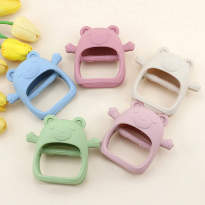 Set of colorful bear-shaped clips on a light background with tulips.