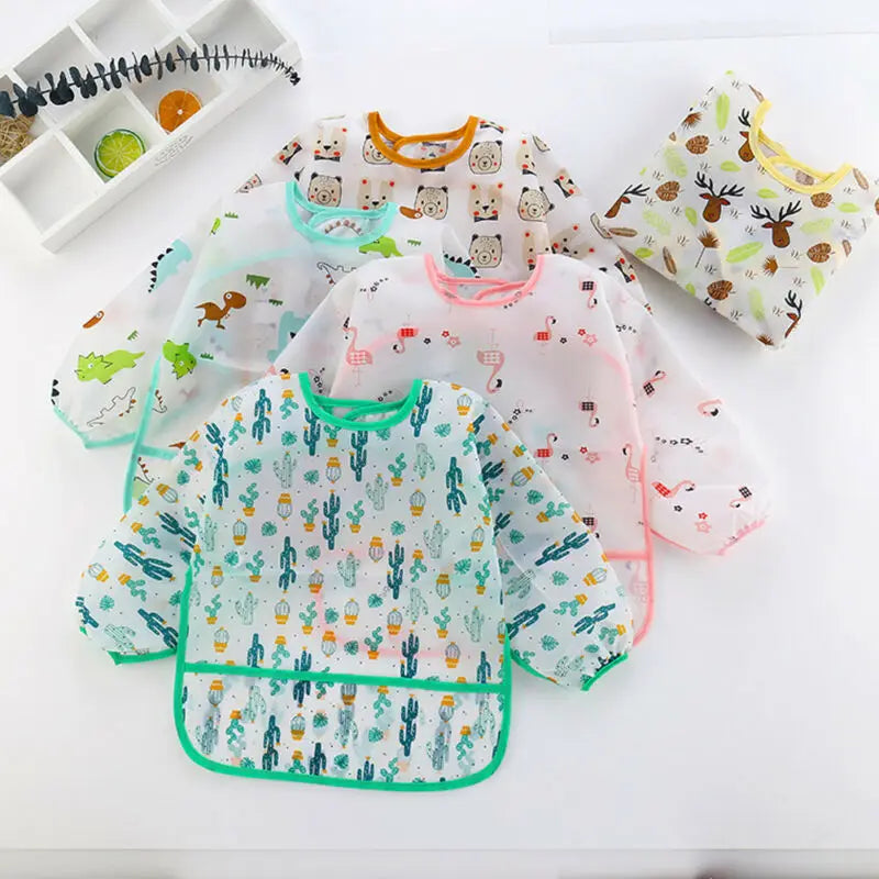 Set of colorful baby bibs with various patterns on a white surface
