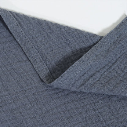 Close-up of textured blue fabric with a white background