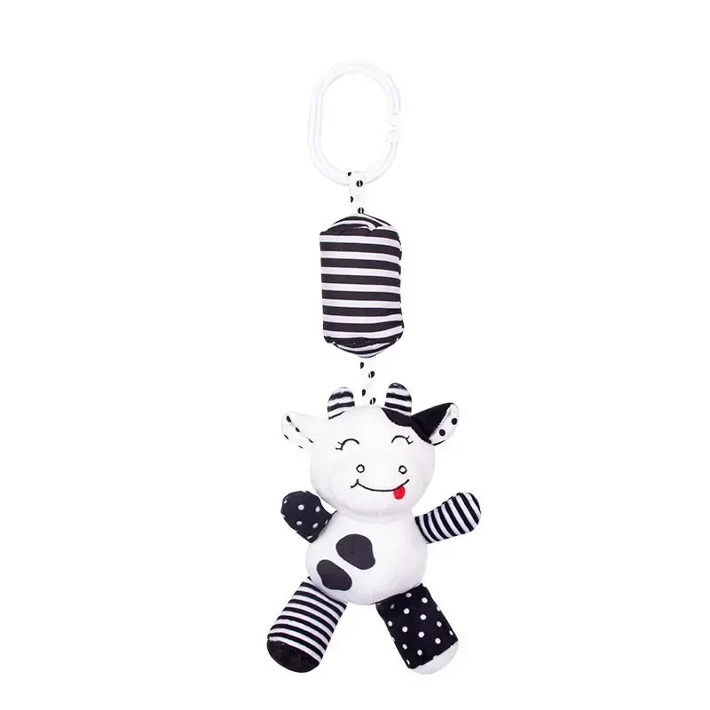 Black and white striped baby toy with a smiling face on a white background