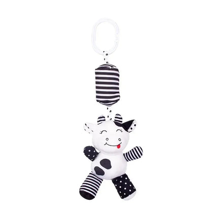 Black and white striped baby toy with a smiling face on a white background