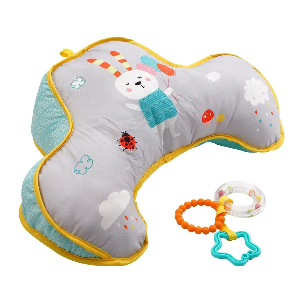 Baby U-shaped pillow with cartoon design and attached teething ring on a white background