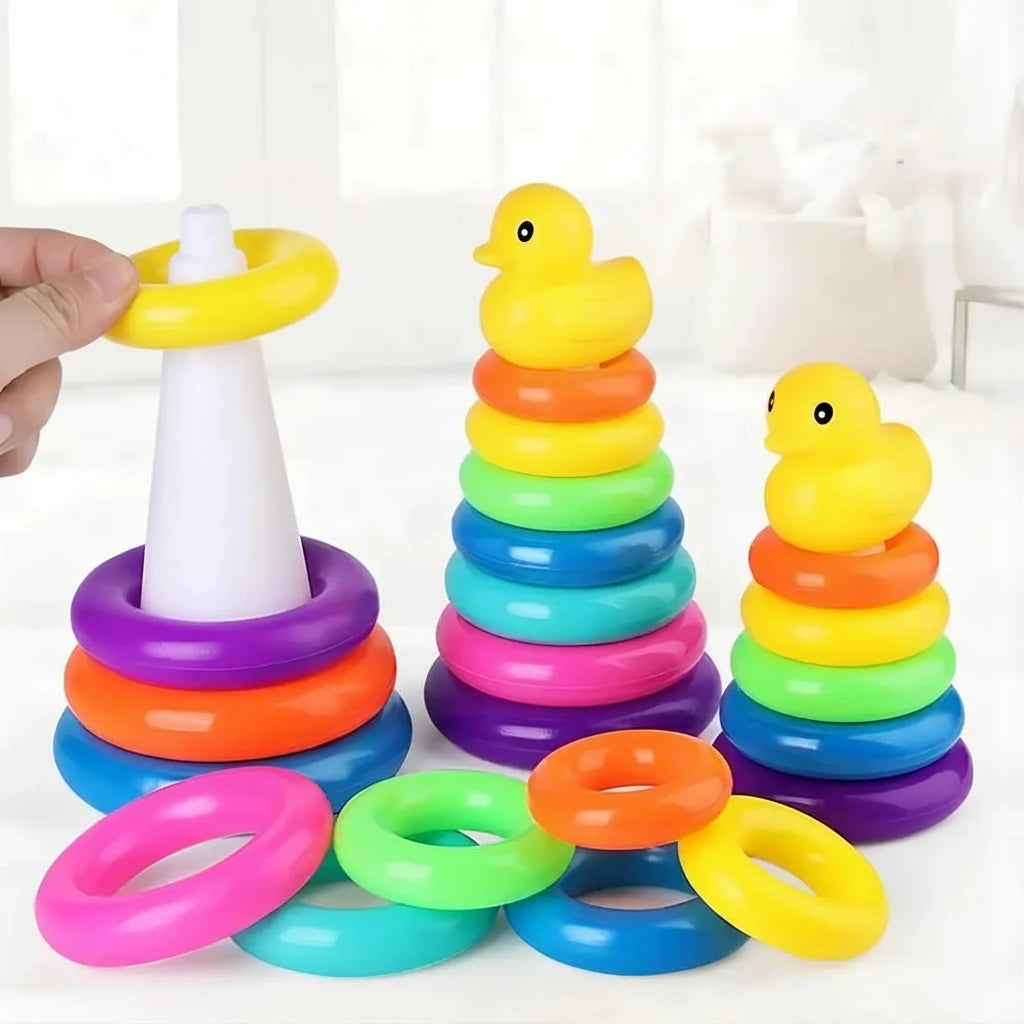 Colorful stacking rings toy with a hand holding one ring, on a white background.