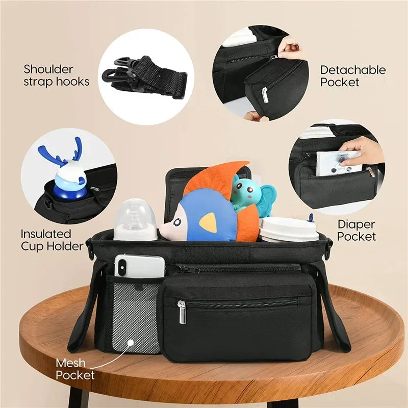 Black diaper bag with features highlighted on a beige background