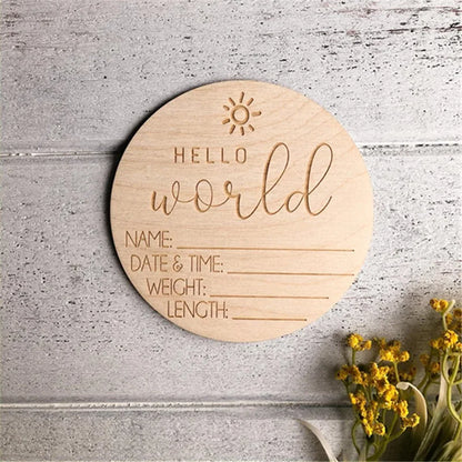 Round wooden board with 'Hello World' engraving on a textured surface with flowers.